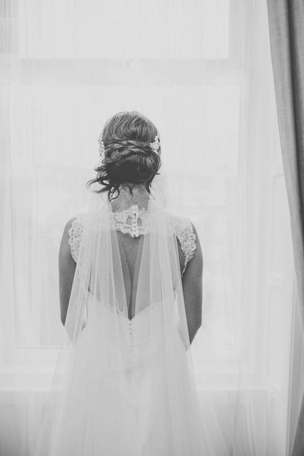 Close up shot of bride wearing a 1920s inspired drape veil in silk effect tulle