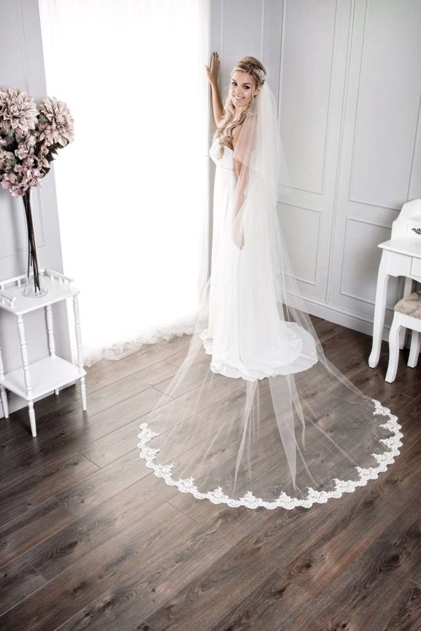 Bride wearing long chapel length veil with a lace bottom