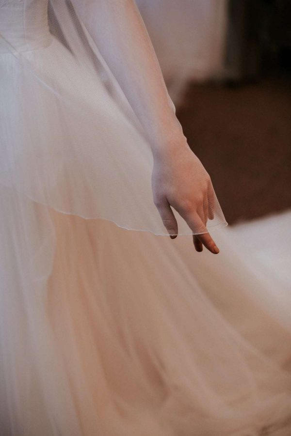 Close up of veil in Silk Effect tulleveil in Silk Effect tulle draped over brides hand