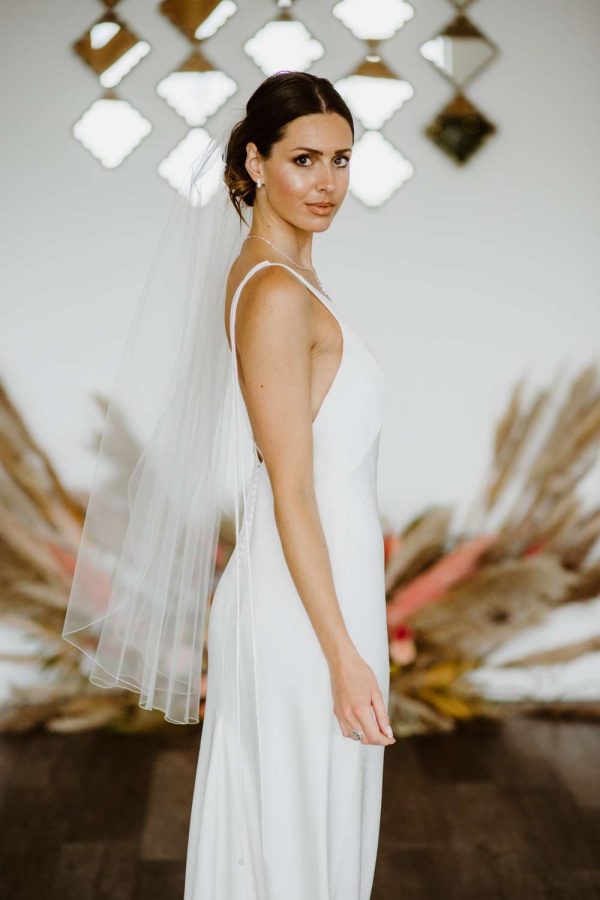 Lauren – single layer fingertip length veil with a pencil edge