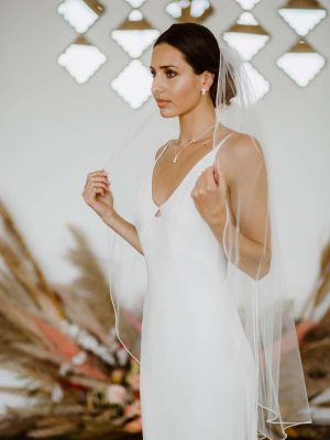 Tania - one layer fingertip length veil with a pearl beaded edge