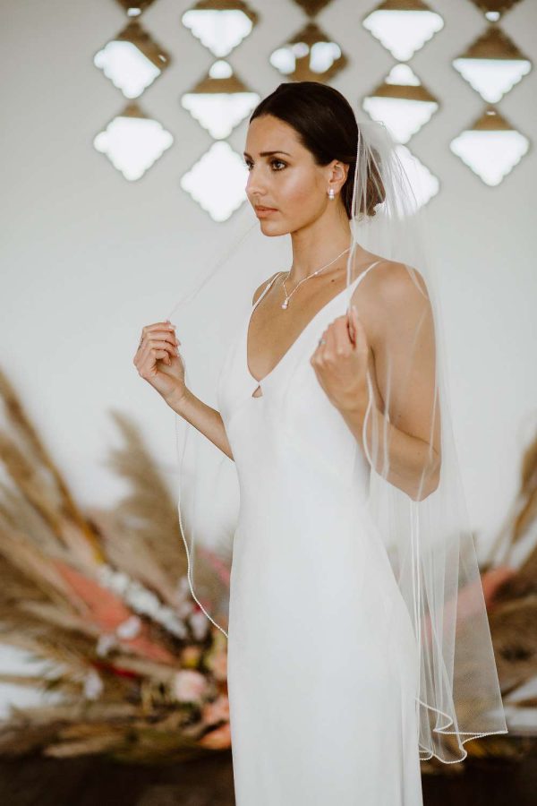 Tania - one layer fingertip length veil with a pearl beaded edge