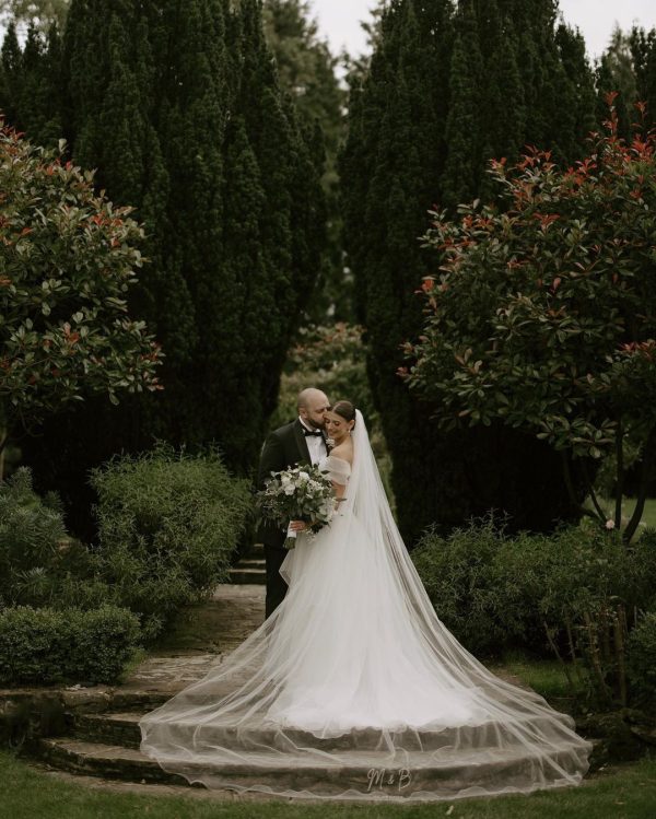 a man and woman in a wedding dress and veil
